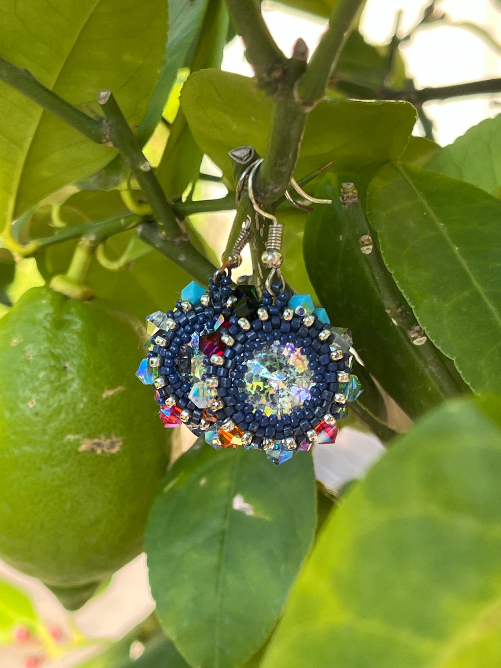 Détail des boucles d'oreilles Iris artisanales, perles Miyuki 1mm et cristaux Swarovski multicolores