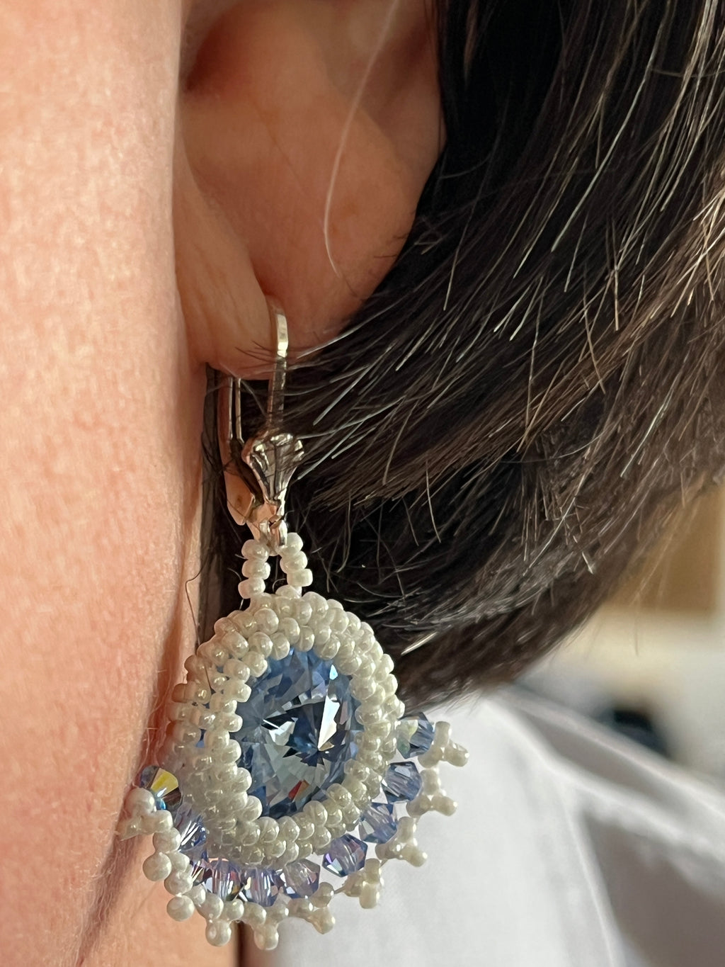 Boucles d'oreilles Clématite artisanales bleu ciel portées, création parisienne